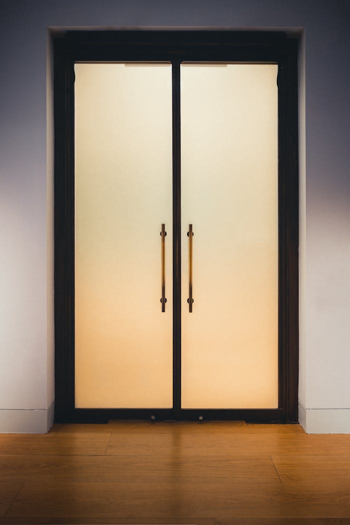 gallery-6 Elegant frosted glass doors with golden handles, perfect for contemporary interior design.