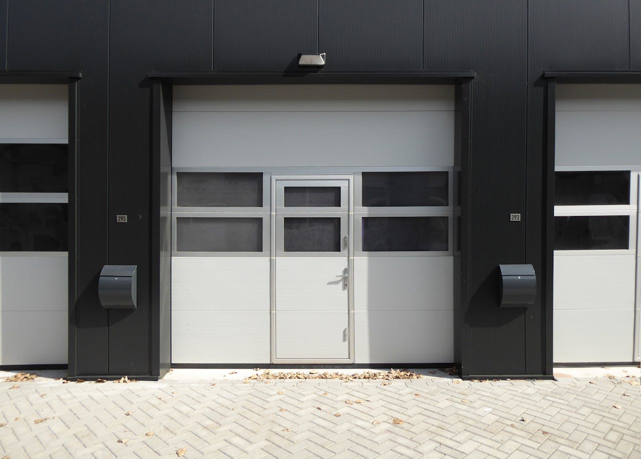 gallery-1 Modern industrial garage door with entrance, suitable for business property.